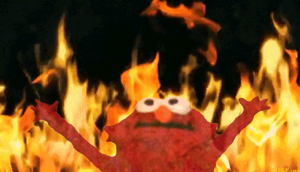 Elmo with his hands raised up like he's unleashing the hellfire crackling behind him